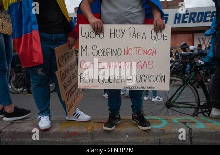 A demonstrator holds a sign that reads 'I fight today for my nephew so he doesn't has to breath tear gas for demanding for his education' as thousands Stock Photo
