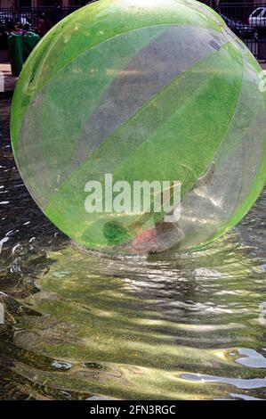 Children playing on an inflatable water waking ride (Zorb ball) at the Malecon 2000 in Guayaquil Ecuador Stock Photo