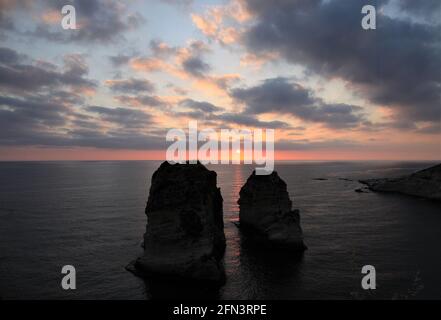 Beirut, Lebanon. 13th May, 2021. Sunset is seen at Raouche Rocks in Beirut, Lebanon, on May 13, 2021. Credit: Liu Zongya/Xinhua/Alamy Live News Stock Photo