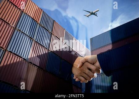 Container Cargo freight ship with working crane bridge in shipyard at dusk for Logistic Import Export background Stock Photo
