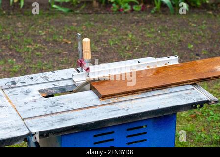 Circular saw cuts wood close up. Cropped picture. Stock Photo