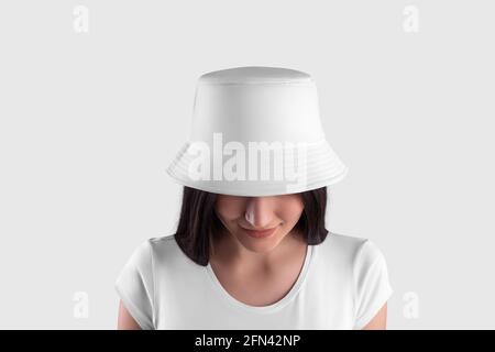 Mockup of a white panama on a dark-haired girl in a T-shirt with her head down, close-up, front view, isolated on background. Fashion hat template, fo Stock Photo