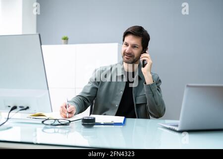 Receptionist Phone Call On Corporate Telephone At Office Stock Photo