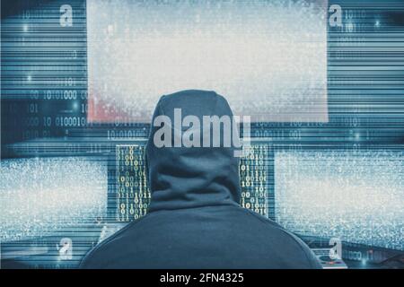 Hacker coding virus ransomware using laptops and computers. Cyber attack, system breaking and malware concept. Stock Photo
