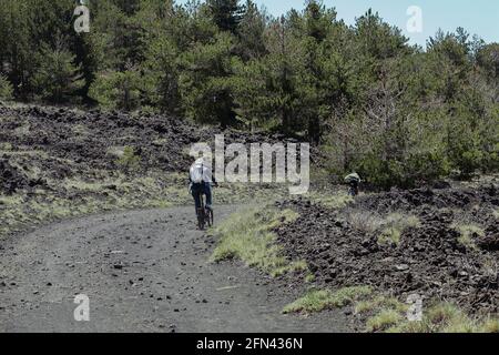 outdoor recreation in Sicily nature mountain biker riding along a path of Etna Park Stock Photo