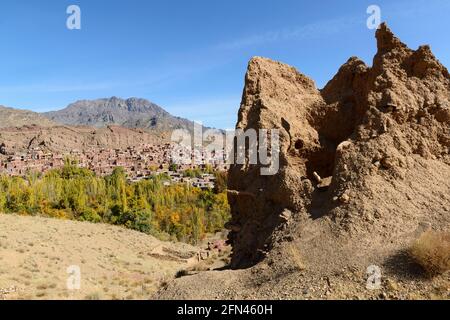 Ruins of an ancient Sasanid fort with the traditional red colored village Abyaneh in the background, Isfahan Province, Iran Stock Photo