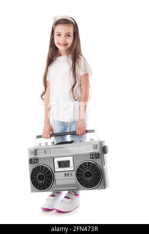 Young hip hop girl listening music on boombox retro radio, ghetto blaster, isolated on white background Stock Photo