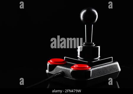Retro joystick from 8-bit consoles. Game controller isolated on black background Stock Photo