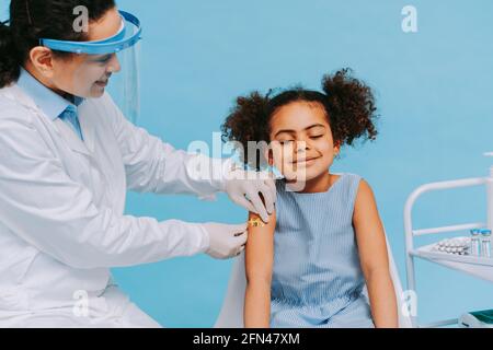 Covid-19 ( coronavirus) vaccination campaign in a clinic - People getting vaccinated from doctor and nurse to prevent corona virus outbreak in a vacci Stock Photo