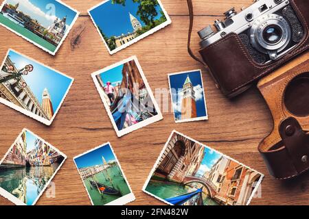 Vintage retro camera with photos from Venice, Italy on wooden background Stock Photo