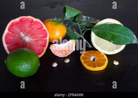 fresh citrus fruits on a black background close-up Stock Photo