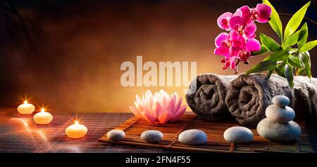 Spa Massage Treatment With Towels And Candles On Mat Stock Photo