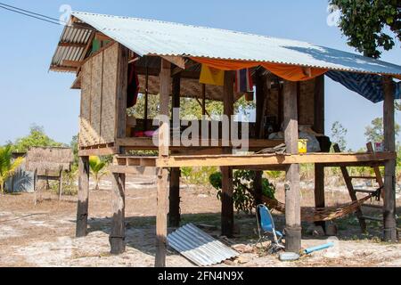 Traditional wooden Thai house elevated on stilts with corrugated iron roof Stock Photo