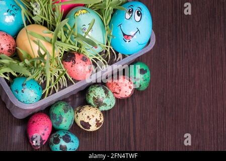 red yellow green and blue eggs lie on the background Stock Photo