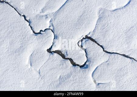 Aerial view of the snowy Pla de Beret in winter. Meanders of the Noguera Pallaresa river near its source (Aran Valley, Catalonia, Spain, Pyrenees) Stock Photo