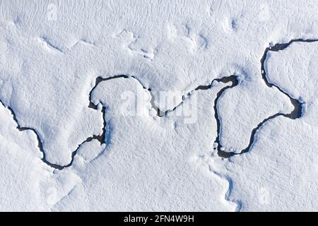 Aerial view of the snowy Pla de Beret in winter. Meanders of the Noguera Pallaresa river near its source (Aran Valley, Catalonia, Spain, Pyrenees) Stock Photo