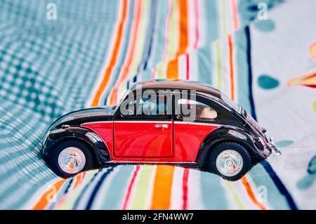 POZNAN, POLAND - Nov 04, 2017: Volkswagen Classic Beetle toy car on a bed sheet Stock Photo