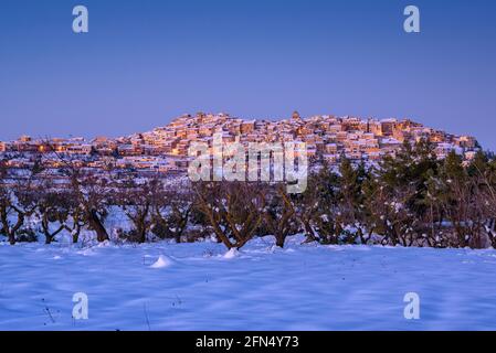 Horta de Sant Joan village, in a winter snowy twilight - blue hour after a heavy snowfall (Terra Alta, Tarragona, Catalonia, Spain) Stock Photo
