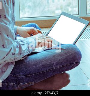 Concept of distance learning, isolation, business, shopping online. Remote working from home. Freelancer workplace in kitchen with laptop. Close up of Stock Photo