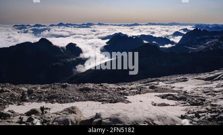 Views from the trail to Aneto summit in summer with a sea of clouds over the Aran Valley (Posets-Maladetas Natural Park, Benasque, Spain, Pyrenees) Stock Photo