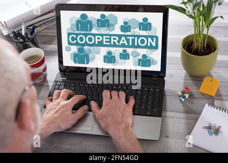 Cooperation concept shown on a laptop used by a man Stock Photo