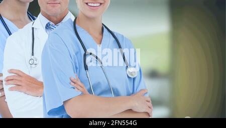 Mid section of team of medical professionals and health workers against hospital in background Stock Photo