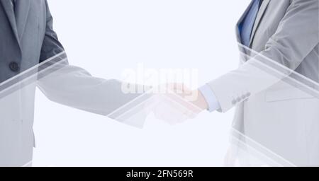 Abstract technology background over two businessmen shaking hands against white background Stock Photo