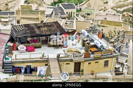 GOREME, TURKEY - May 05, 2014: Hotel village tables with tables of cafe, Pansion garden is town in Nevsehir Province, Central Anatolia, Turkey Stock Photo