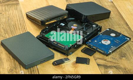 Pile of hdd memory storage devices over dark surface,tech components,usb,memory Stock Photo