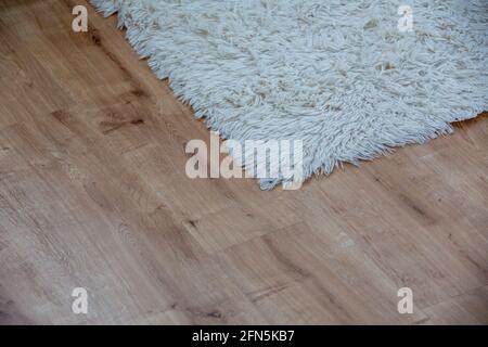white carpet on parquet floor. Top view Stock Photo