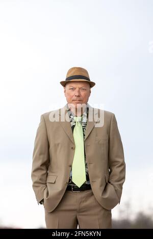 portrait of handsome man in his 50s in beige suit from the 1980s Stock Photo