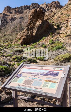 Volcanic rock formation known as the Queens Slipper, Zapatilla de la Reina, carved out by wind and rain erosion, with explanatory sign in the Las Cana Stock Photo