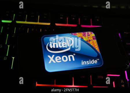 Viersen, Germany - May 8. 2021: Closeup of smartphone with logo lettering of intel xeon processor cpu on computer keyboard Stock Photo
