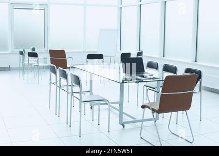 Flipchart glass table chairs in office space. The concept of training in the office of a large company Stock Photo