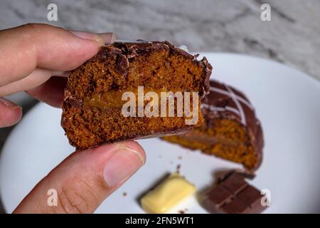 Brazilian  gingerbread (honey bread) in a male hand. Top view and selective focus Stock Photo