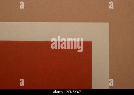 Multi colored abstract paper of pastel beige, orange,brown colors palette, with geometric shape, flat lay. Stock Photo