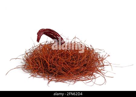 Chilli threads and chilli pod against white background Stock Photo