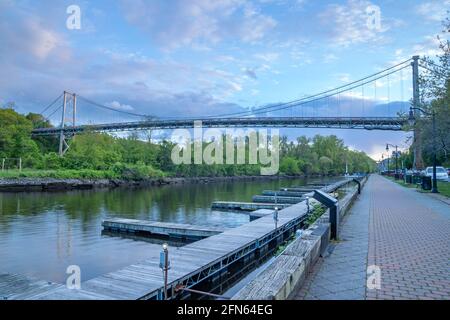 Kingston, NY - USA- May 12, 2021: a landscape view of the Wurts Street Bridge or the The Kingston–Port Ewen Suspension Bridge, is a steel suspension b Stock Photo