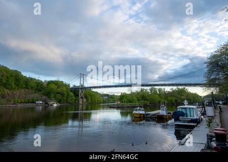 Kingston, NY - USA- May 12, 2021: a landscape view of the Wurts Street Bridge or the The Kingston–Port Ewen Suspension Bridge, is a steel suspension b Stock Photo