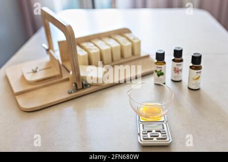 A soap-maker weighs aromatic oils for making cosmetics on a kitchen scale.  Home spa. Small business Stock Photo - Alamy