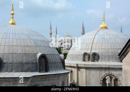 View from Hagia Sophia looking over the domed buildings to the Blue mosque in the distance. Classic view of Istanbul, Turkey. Stock Photo