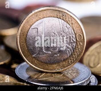 Beautiful one euro coin standing on pile Stock Photo