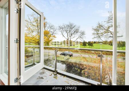 Open window to balcony viewing countryside road Stock Photo