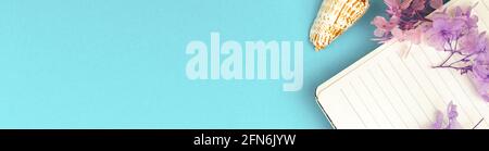 Writing Diary concept, banner summer vacation with copy space, notebook with flowers and sea shells on colorful background, top view and flat lay Stock Photo