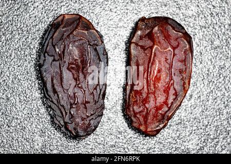 Two large dried dates on black and white background Stock Photo