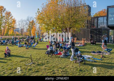 Kazan, Russia - October 03, 2020: Residents walk, relax, sit and lie on the lawn in the city park on a sunny autumn day Stock Photo