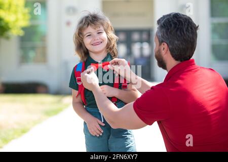 Funny nerd. Father supports and motivates son. Kid going to primary school. Kids education. Smart wunderkind in school uniform ready to school. Stock Photo