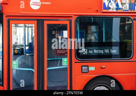 Red double decker bus with 31 via Notting Hill Gate signage Stock Photo
