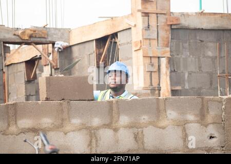 a bricklayer laying bricks on site Stock Photo