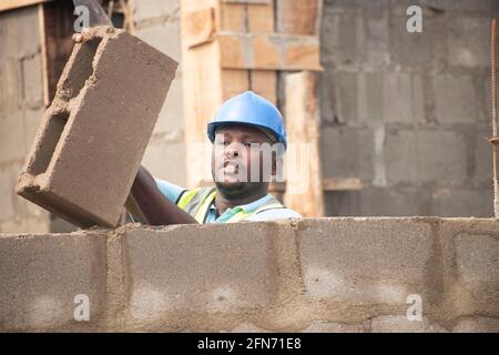 a bricklayer laying bricks on site Stock Photo